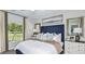 Comfortable bedroom with large window, neutral walls, stylish decor, and lots of natural light at 5113 Forget Me Not Ave, Lake Hamilton, FL 33851