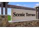 The community sign reads 'Scenic Terrace' with stone accents and landscaping at 5113 Forget Me Not Ave, Lake Hamilton, FL 33851