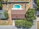 Aerial view shows a property with a kidney-shaped pool, fenced yard and brown shingle roof at 601 Francis St, Kissimmee, FL 34741
