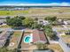 Aerial view shows a property with a kidney-shaped pool and fenced yard close to the local airport at 601 Francis St, Kissimmee, FL 34741