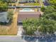 Backyard features a lovely pool, surrounded by a white privacy fence, with mature trees at 601 Francis St, Kissimmee, FL 34741
