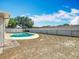 Private backyard features a sparkling in-ground pool, and white fence at 601 Francis St, Kissimmee, FL 34741