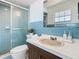 Well-lit bathroom featuring vanity, toilet, and glass shower at 601 Francis St, Kissimmee, FL 34741