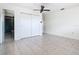 Bedroom featuring ceiling fan, tiled flooring, and walk-in closet at 601 Francis St, Kissimmee, FL 34741