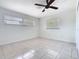 Bedroom with ceiling fan, neutral walls, and tiled floors at 601 Francis St, Kissimmee, FL 34741