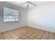 Bright bedroom with tile flooring and a large window, offering natural light and a simple, clean aesthetic at 601 Francis St, Kissimmee, FL 34741