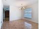 Bright dining area with tiled floor, chandelier, and large window providing natural light at 601 Francis St, Kissimmee, FL 34741