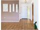 Bright foyer featuring tiled flooring leading to front door, accented by minimalist wall decor at 601 Francis St, Kissimmee, FL 34741