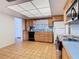 Functional kitchen featuring wood cabinetry, essential appliances, tiled floors, and a bright window at 601 Francis St, Kissimmee, FL 34741