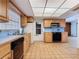 Well-lit kitchen with wooden cabinets, black appliances, and tile flooring, combining classic design with practicality at 601 Francis St, Kissimmee, FL 34741