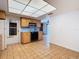Spacious kitchen area with tile flooring, ready for customization and furnishing, blending functionality with potential at 601 Francis St, Kissimmee, FL 34741