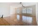 Bright living room with tiled flooring, large windows, and ceiling fan with light fixture at 601 Francis St, Kissimmee, FL 34741