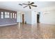 Open living room with tiled floors, ceiling fan, connecting to dining and kitchen areas at 601 Francis St, Kissimmee, FL 34741