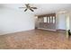 Spacious living room with tiled flooring, ceiling fan, neutral walls, and stylish mirror accents at 601 Francis St, Kissimmee, FL 34741