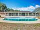 Backyard with an in-ground kidney-shaped pool enclosed by a screened lanai offers a private outdoor space at 601 Francis St, Kissimmee, FL 34741