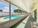Screened-in lanai overlooks a refreshing swimming pool with a white fence at 601 Francis St, Kissimmee, FL 34741