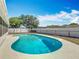 Backyard features an in-ground kidney-shaped pool enclosed by a screened lanai, a perfect outdoor space at 601 Francis St, Kissimmee, FL 34741