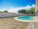 Backyard with an in-ground kidney-shaped pool enclosed by a screened lanai offers a private outdoor space at 601 Francis St, Kissimmee, FL 34741