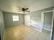 Relaxing bedroom featuring a ceiling fan, closet and a window at 606 E Central Ave, Eagle Lake, FL 33839