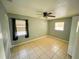 Comfortable bedroom with tile floors, ceiling fan, and natural light at 606 E Central Ave, Eagle Lake, FL 33839