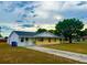 Charming home with a well-manicured lawn and mature tree at 606 E Central Ave, Eagle Lake, FL 33839