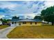 Charming single-story home featuring a cozy front porch and well-maintained lawn at 606 E Central Ave, Eagle Lake, FL 33839
