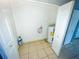 Practical laundry area with tile flooring, hook ups, and easy access at 606 E Central Ave, Eagle Lake, FL 33839