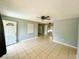 Spacious living room with tiled floors and neutral paint throughout at 606 E Central Ave, Eagle Lake, FL 33839