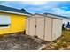 The storage shed is located in the backyard at 606 E Central Ave, Eagle Lake, FL 33839