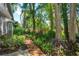 Beautifully landscaped backyard path with lush tropical plants and trees at 617 Red Oak Cir # 121, Altamonte Springs, FL 32701