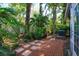 Lush tropical backyard landscaping around brick and paver patio at 617 Red Oak Cir # 121, Altamonte Springs, FL 32701