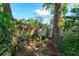 Tropical backyard garden featuring lush plants and a brick path at 617 Red Oak Cir # 121, Altamonte Springs, FL 32701