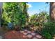 Brick patio and lush tropical backyard landscaping create a tranquil outdoor space at 617 Red Oak Cir # 121, Altamonte Springs, FL 32701