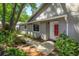 Home exterior showcasing landscaped walkway leading to the red front door at 617 Red Oak Cir # 121, Altamonte Springs, FL 32701