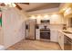 Well-lit kitchen with stainless steel refrigerator, white cabinets, and modern appliances at 617 Red Oak Cir # 121, Altamonte Springs, FL 32701