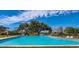 Community pool surrounded by mature trees and lounge chairs on a sunny day at 617 Red Oak Cir # 121, Altamonte Springs, FL 32701