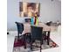 Modern dining area featuring stylish table set, abstract art, and white shelving, perfect for hosting at 6216 Beaumont Ave, Orlando, FL 32808