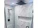 Modern shower featuring grey tiles, a built-in shelf, and a rainfall shower head at 6216 Beaumont Ave, Orlando, FL 32808
