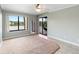 Bedroom featuring neutral paint, fan, lake view, carpet, and access to a screened patio at 652 Lake Villas Dr # D, Altamonte Springs, FL 32701