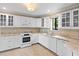 Bright kitchen featuring granite counters, stainless steel appliances, and white cabinetry at 652 Lake Villas Dr # D, Altamonte Springs, FL 32701