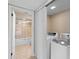 A view of the laundry room showing the side by side washer and dryer adjacent to bathroom at 652 Lake Villas Dr # D, Altamonte Springs, FL 32701