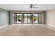 Spacious living room with large sliding doors opening to a balcony overlooking the water at 652 Lake Villas Dr # D, Altamonte Springs, FL 32701