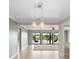 Inviting living room with lake view, modern lighting, neutral paint, and hanging patio chairs at 652 Lake Villas Dr # D, Altamonte Springs, FL 32701