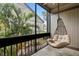 Enjoy serene views from this screened porch with a comfortable hanging chair and lush greenery at 652 Lake Villas Dr # D, Altamonte Springs, FL 32701