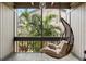 Relax on this cozy screened porch, featuring a hanging chair with a view of tropical foliage at 652 Lake Villas Dr # D, Altamonte Springs, FL 32701