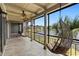 A view of the screened porch, complete with tiled floor and hanging chairs, offering views of the lake at 652 Lake Villas Dr # D, Altamonte Springs, FL 32701