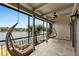 A cozy screened porch with hanging chairs offering serene views of the lake and lush landscaping at 652 Lake Villas Dr # D, Altamonte Springs, FL 32701