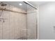 Shower with glass door, tile surround, and pebble floor at 652 Lake Villas Dr # D, Altamonte Springs, FL 32701