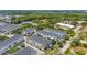 Aerial view of townhouses in a neighborhood with tree landscaping and greenery at 704 Grado Pt, Oviedo, FL 32765