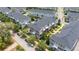 An aerial view of the complex with gray and blue townhomes and street parking at 704 Grado Pt, Oviedo, FL 32765
